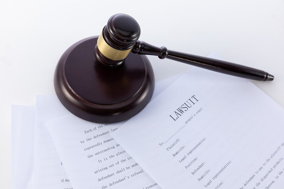 A gavel placed over lawsuit paperwork