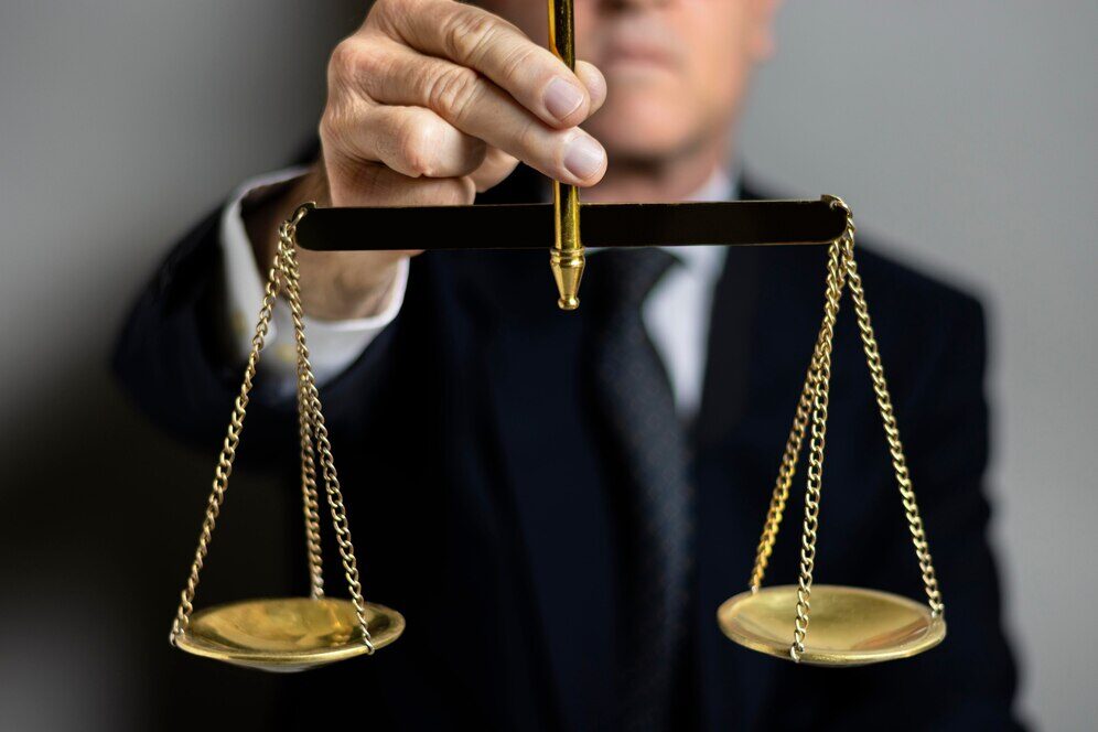 A person holding a balance scale