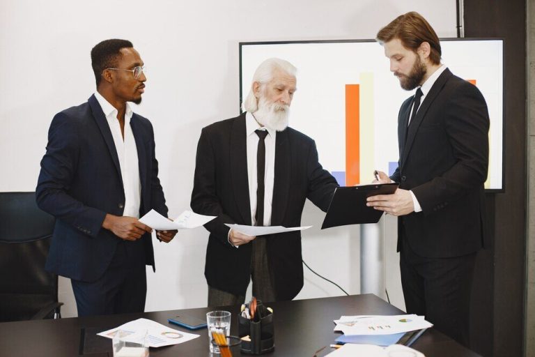 An employee showing a file to two other people