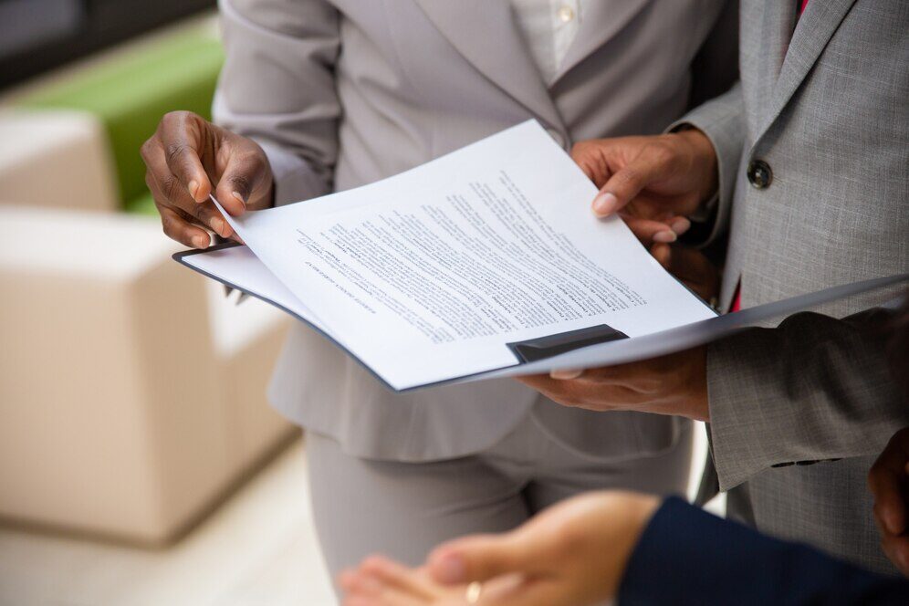 Two people looking at papers in a file