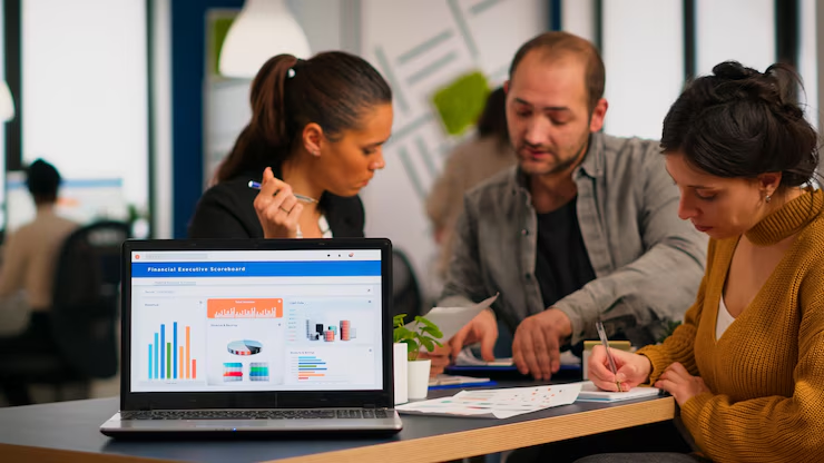 Three people working in an office