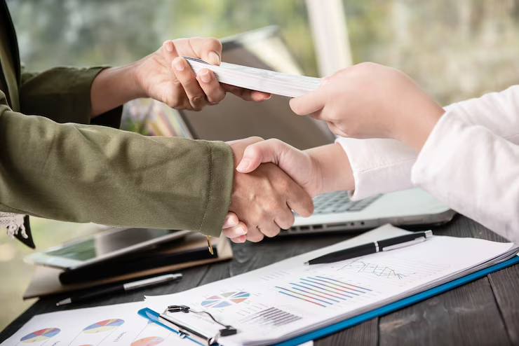 Two people exchanging cash
