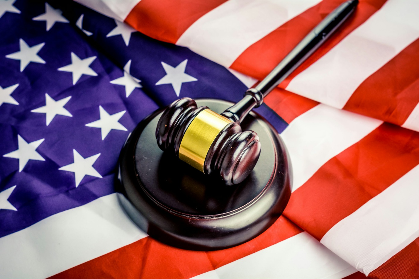 A black hammer and block on the U.S. flag
