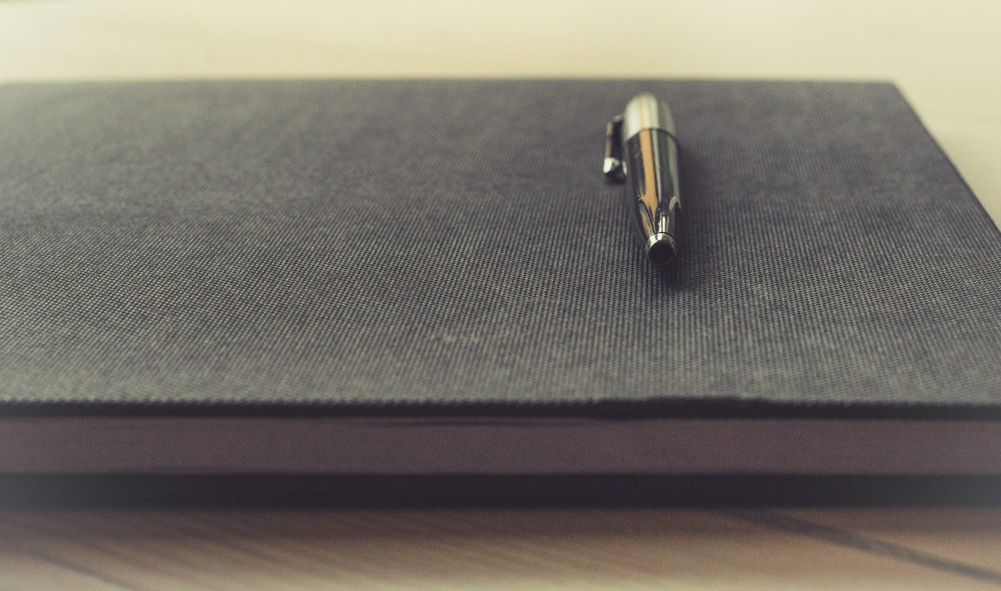 A pen on a black book