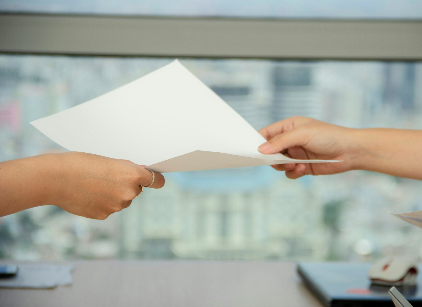 Hands exchanging a piece of paper