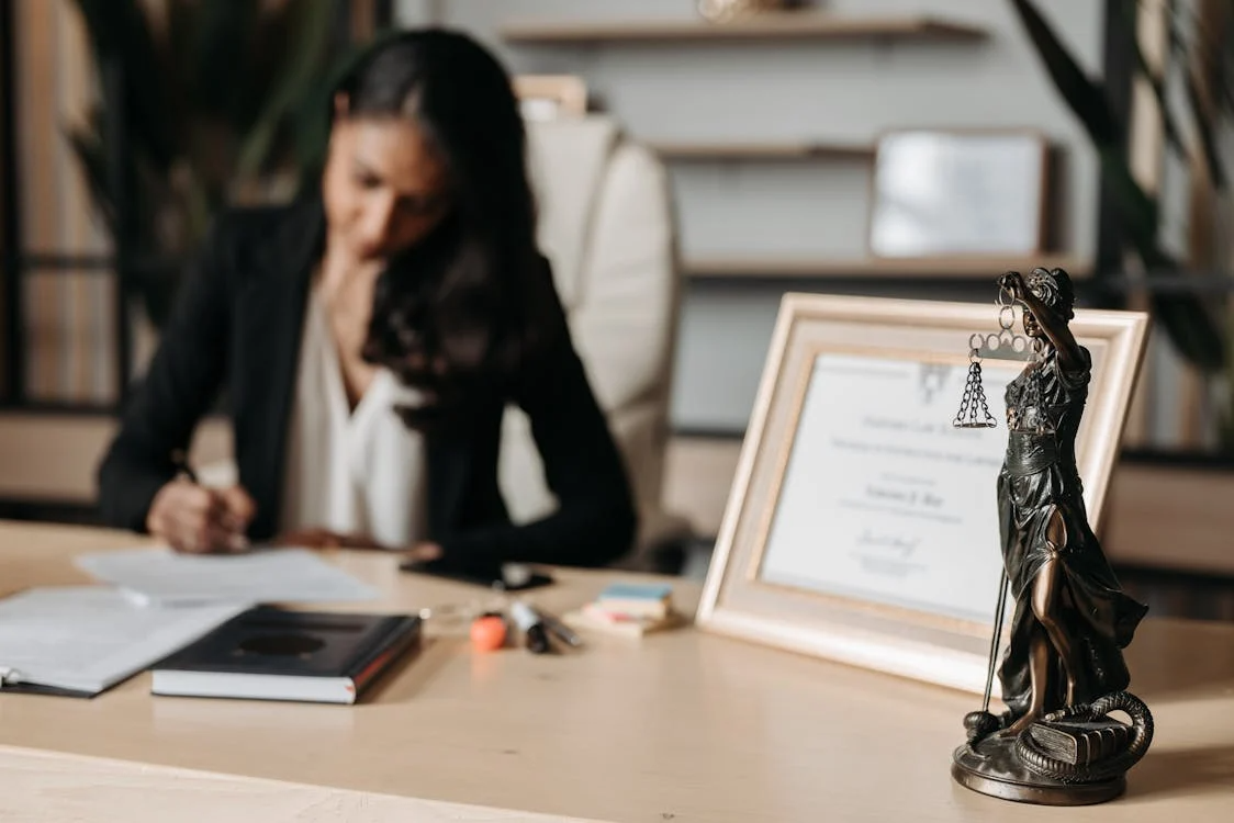 Lady Justice statue placed on a wooden office table.