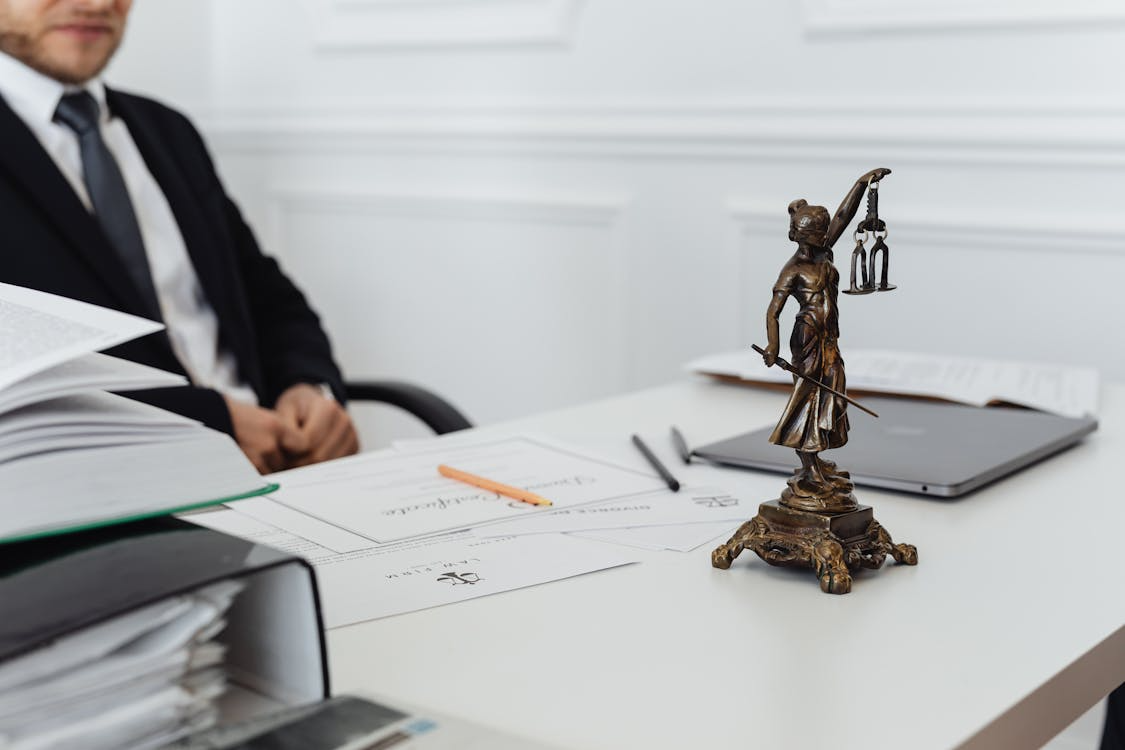 Lawyer working at a desk behind legal documents.