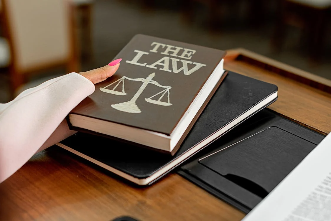 Person holding a law book during a review.