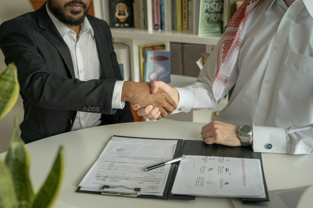 Two men shaking hands over a contract
