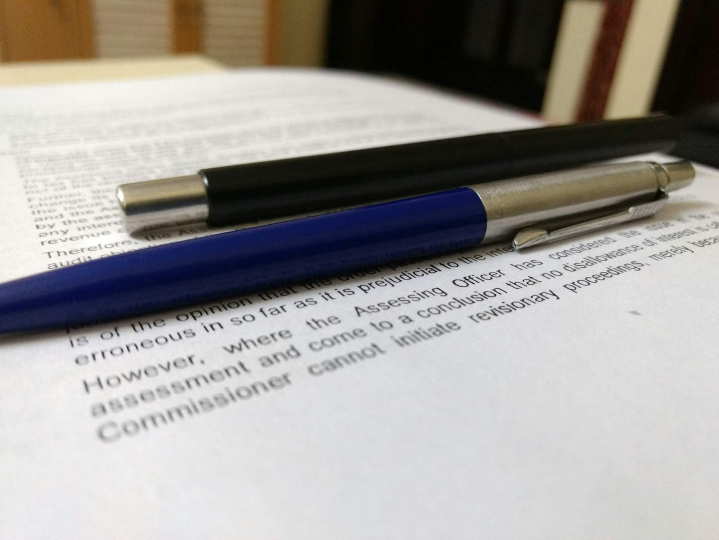 Two pens on a piece of paper with text on it