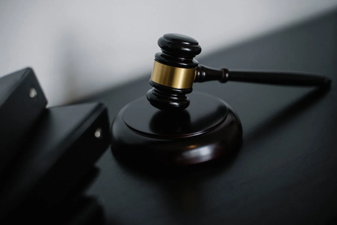 Wooden gavel on a judge’s bench.