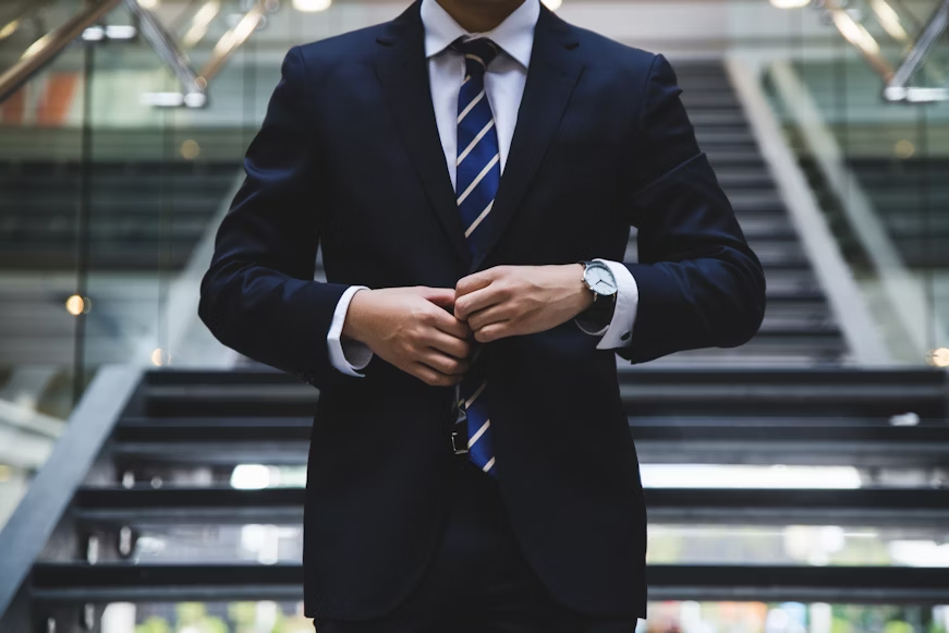 a man buttoning his suit