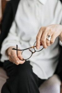 person-holding-brown-framed-eyeglasses