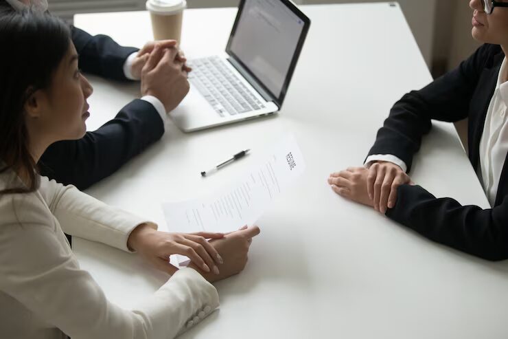 Three people discussing a document