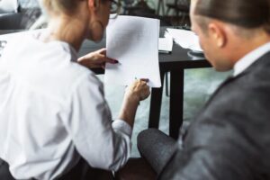 Two people discussing a document