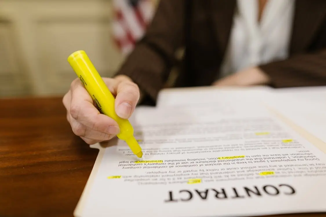 A person highlighting a contract