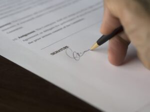 A person signing a contract.