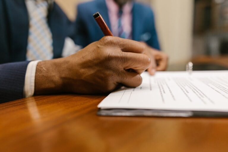 Close-up of a person signing a contract