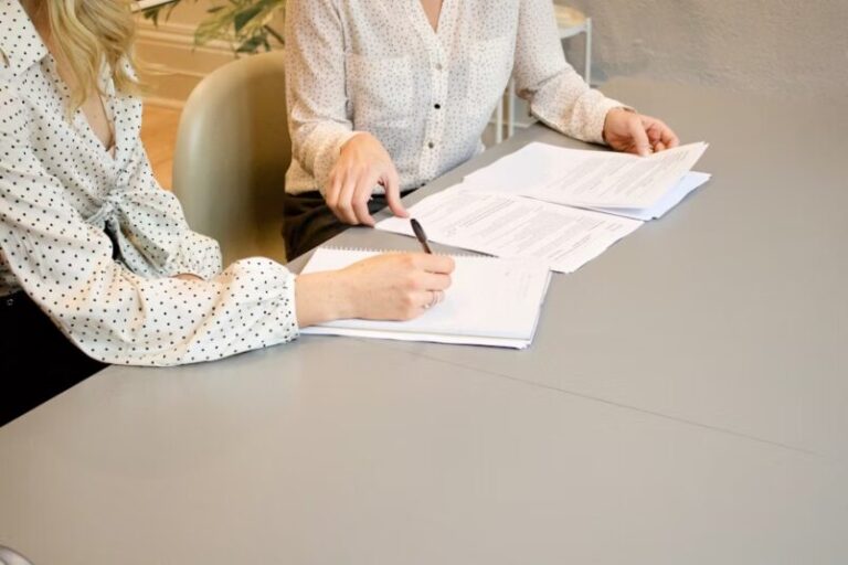 Two people reviewing documents