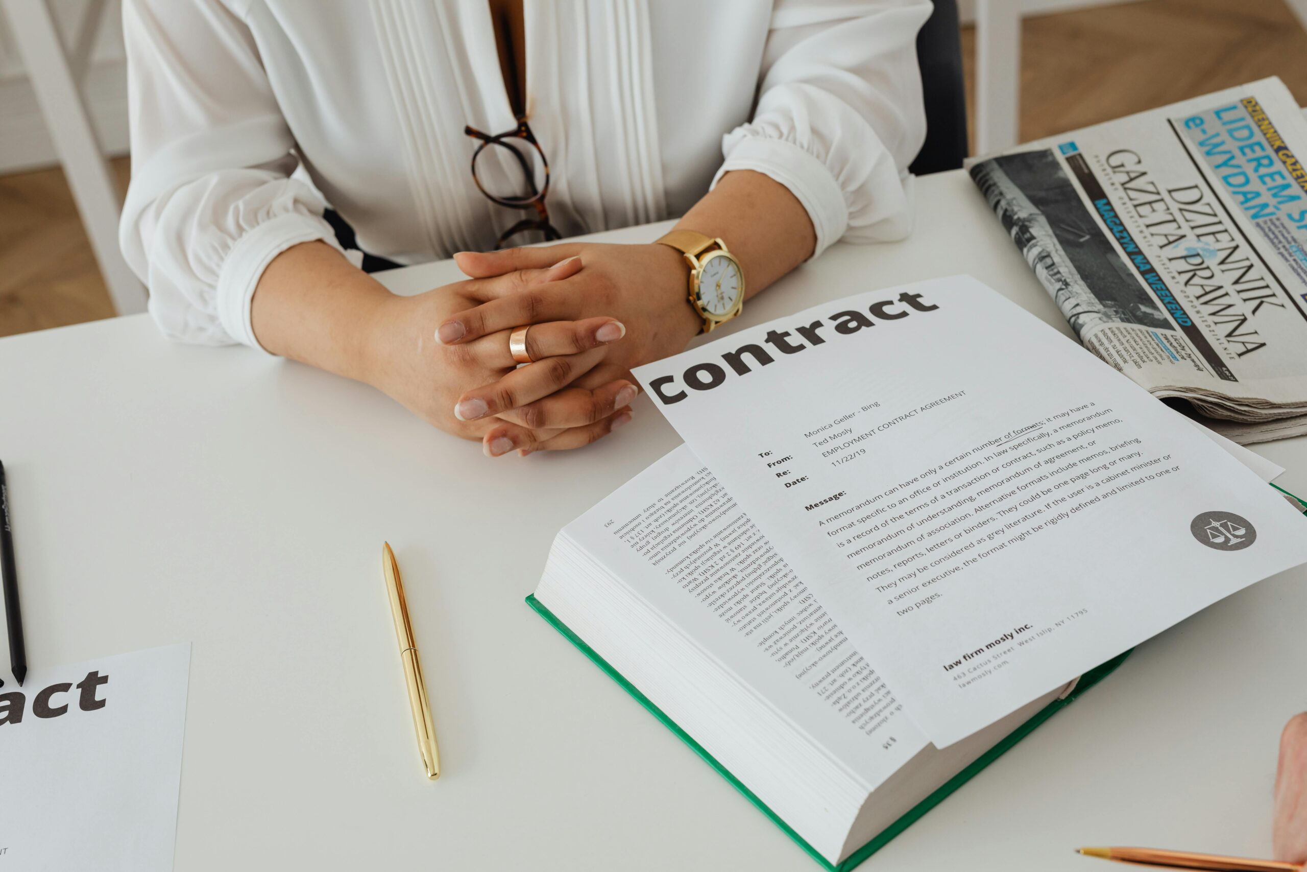 A contract over a book on a desk
