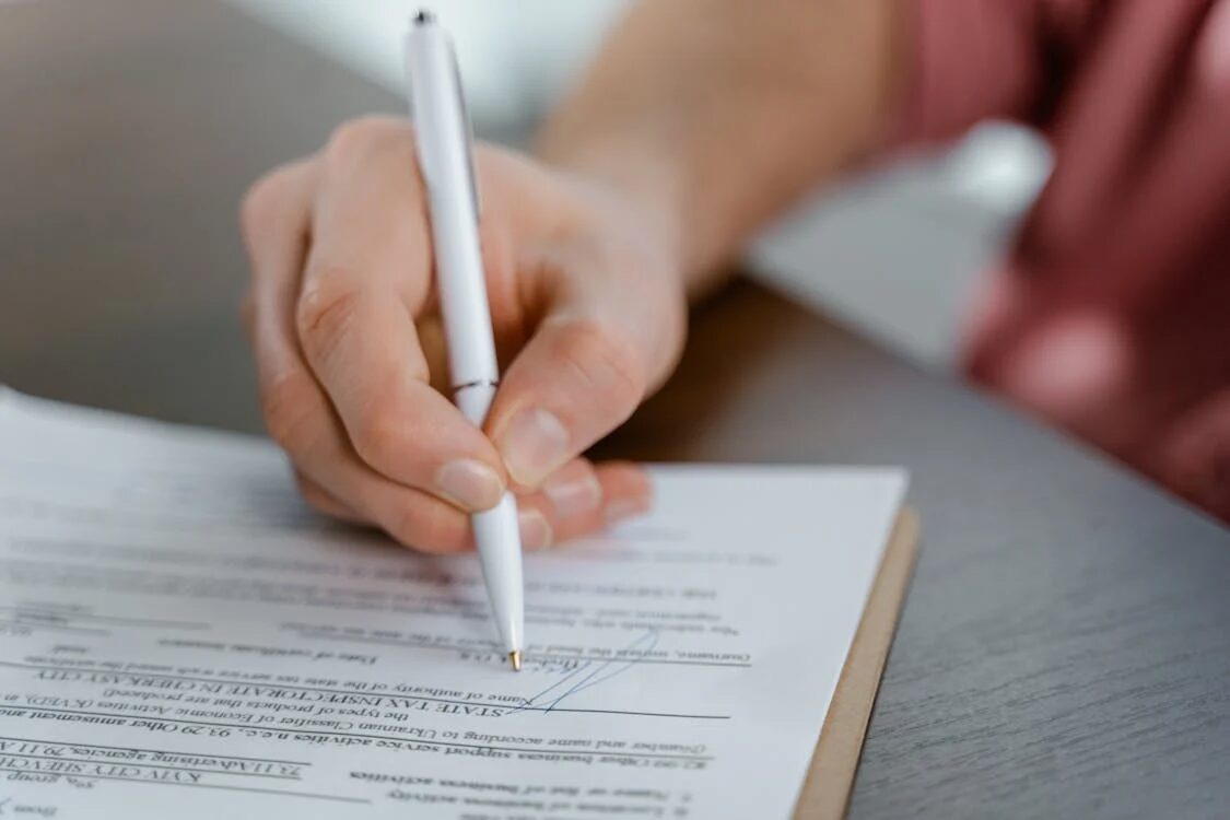 A person signing a paper