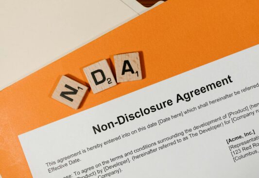 This photo shows a white paper on an orange table.