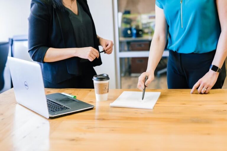 Two people checking a contract placed on a table