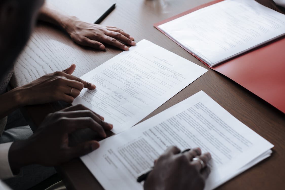 Two people reviewing papers at a table