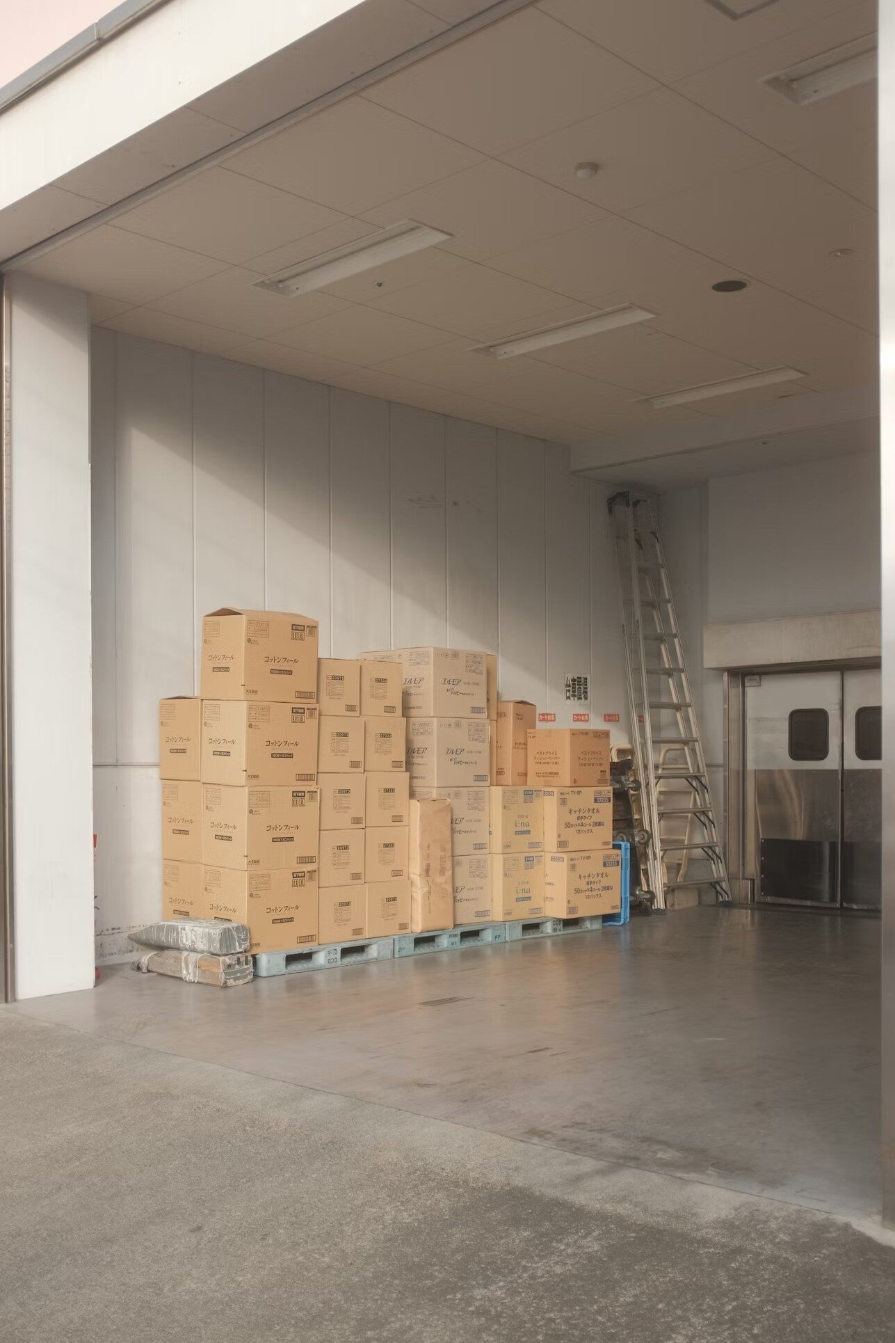 Cardboard boxes next to a ladder in a room
