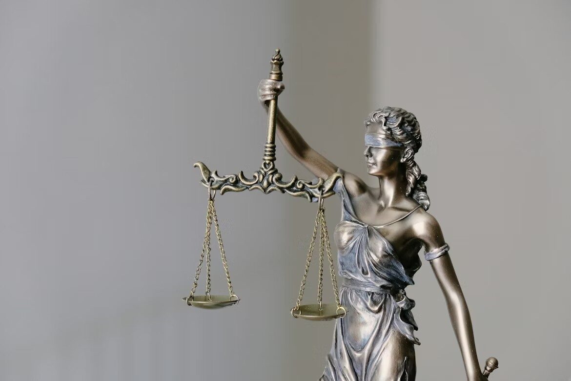 The justice figurine holding a balance scale