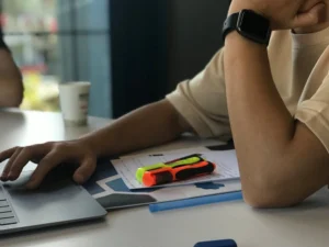 A person using a laptop at their desk