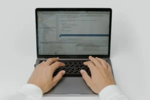 Two people reviewing documents with a tablet in the background