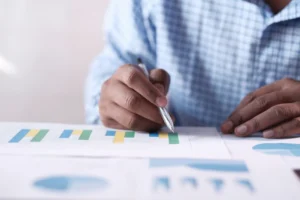 A person reviewing a graph