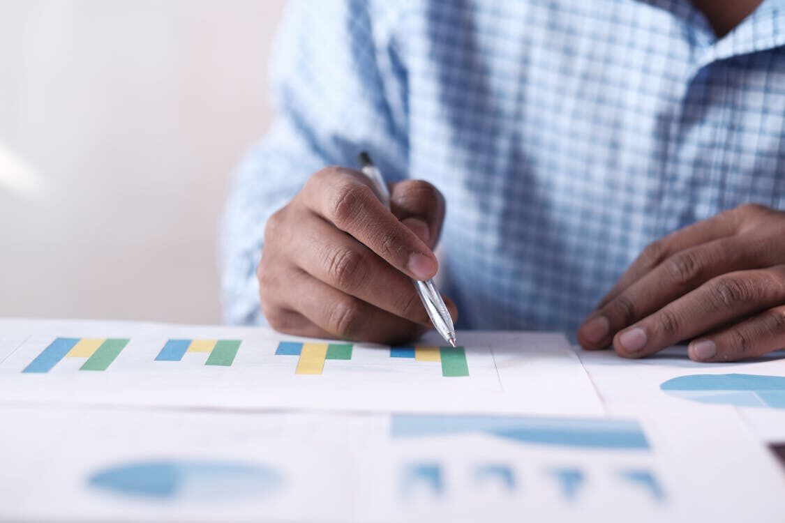 A person reviewing a graph