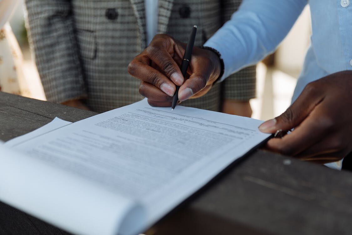 A person writing on white paper