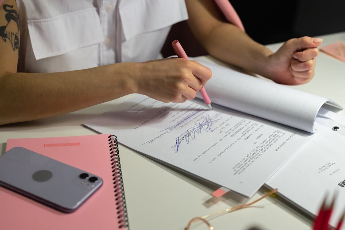 A person writing on a paper