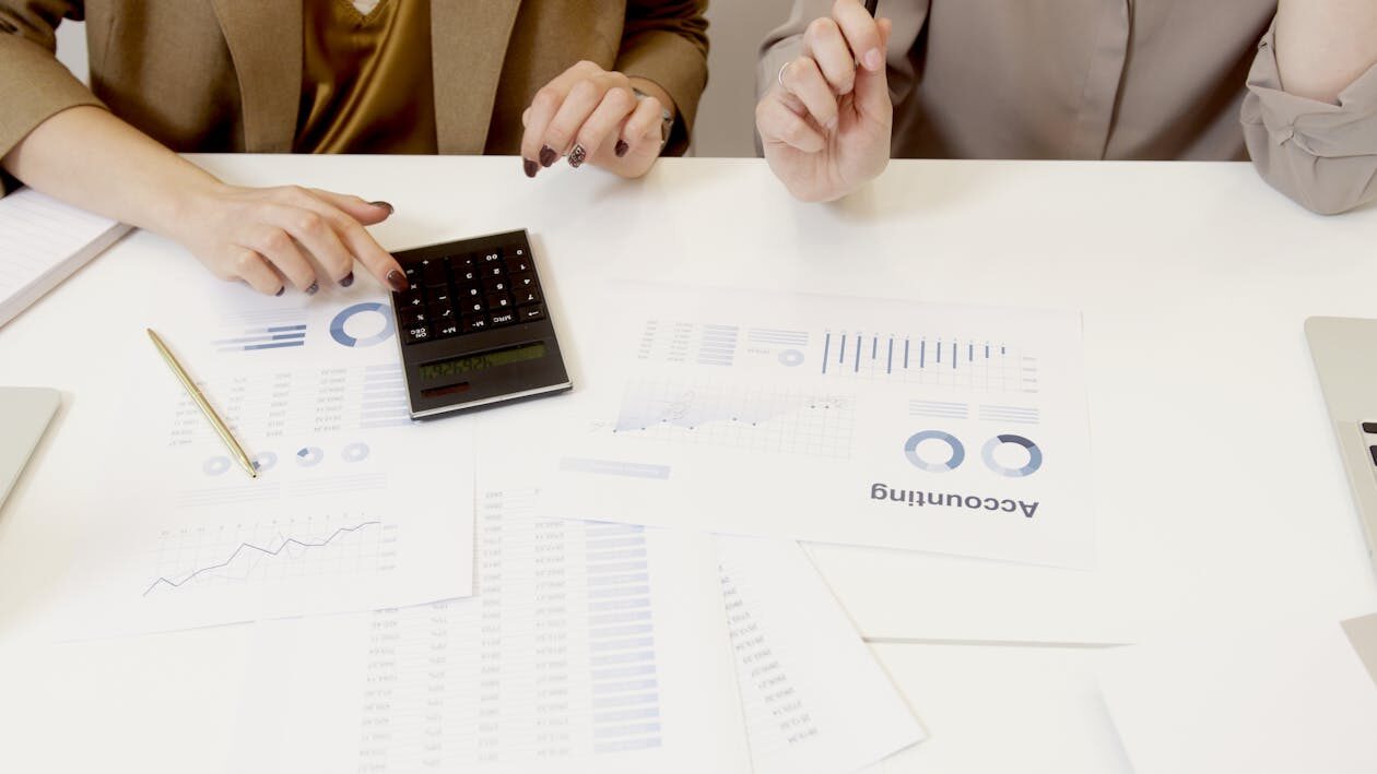 Two people reviewing documents placed on a table
