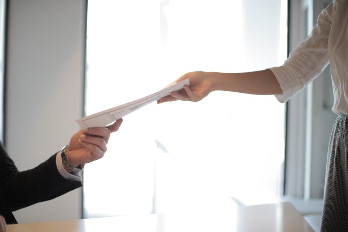 An employer handing a document to an employee