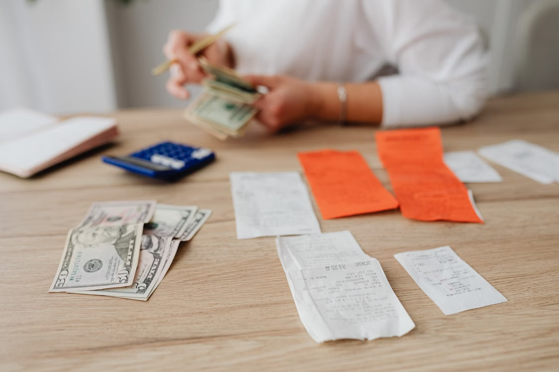 Money, calculator, and receipts on a table