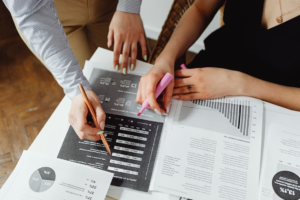Two people reviewing finance documents