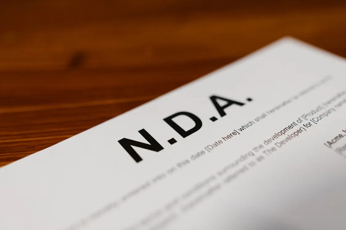 Close-up view of printed text and signature line on a legal non-disclosure agreement.