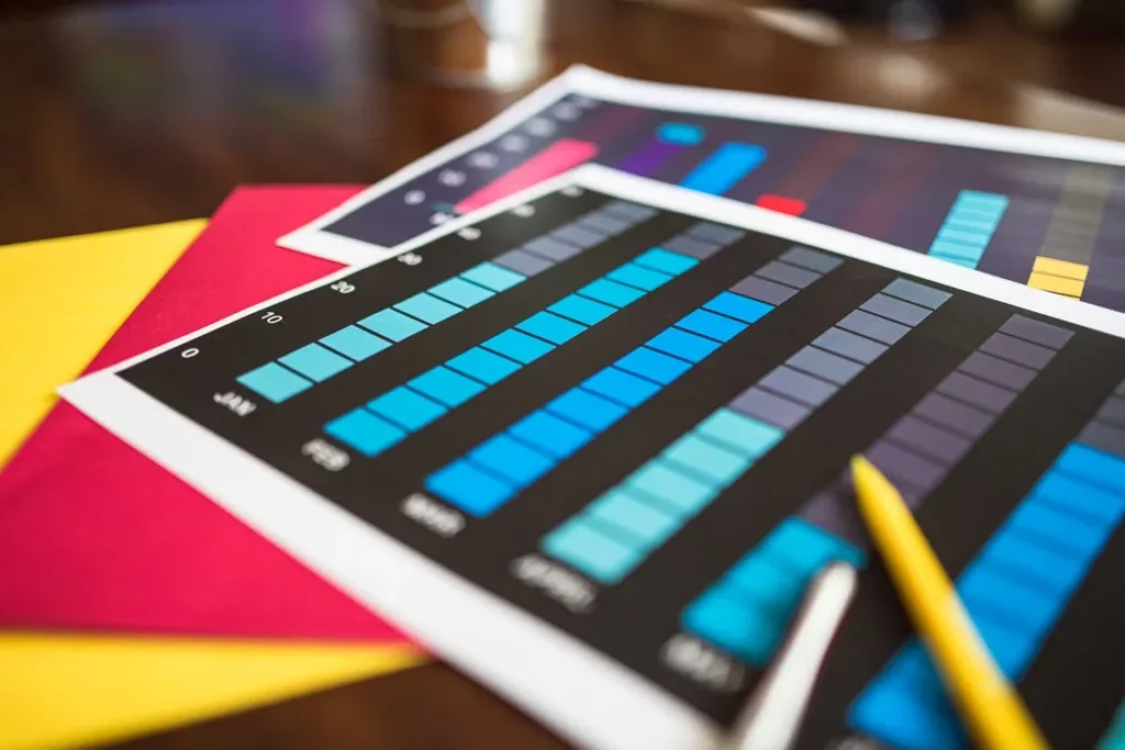 Financial charts and pens on a desk