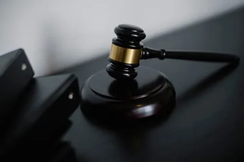 A dark wooden gavel resting on a conference table