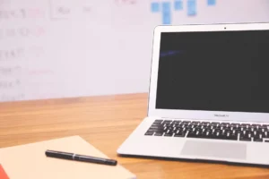 A MacBook Air and documents on the table
