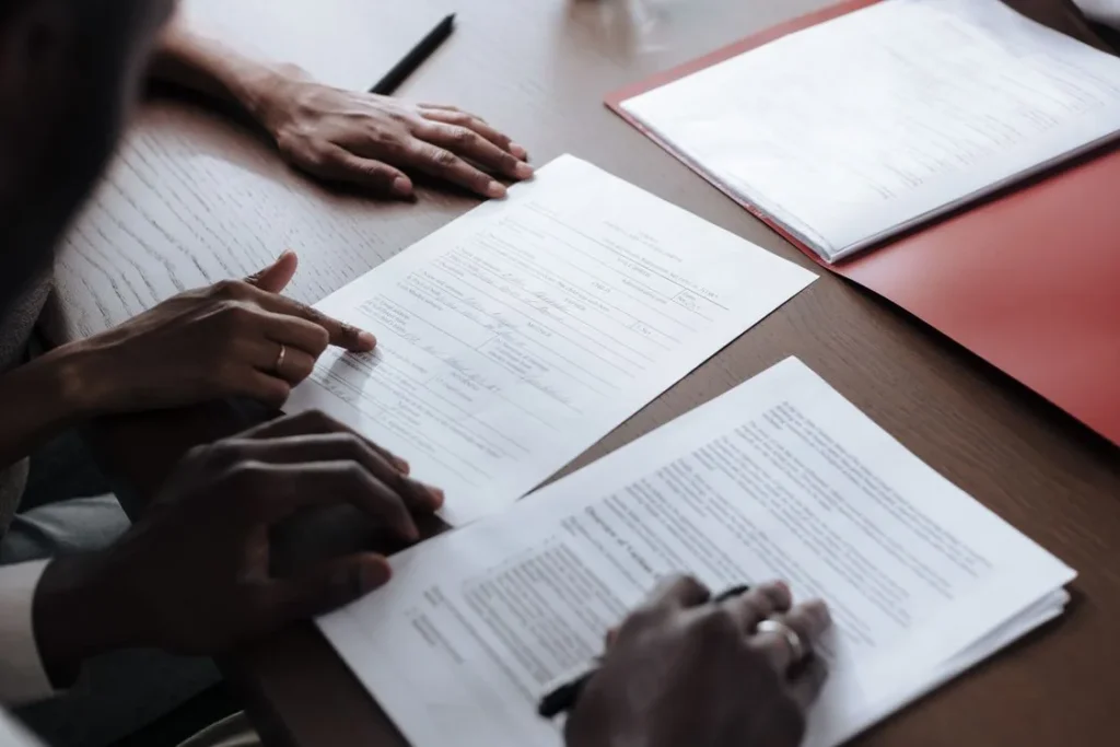 Two people reviewing papers on a table
