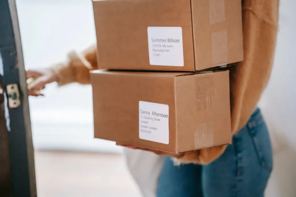 A person carrying delivery boxes