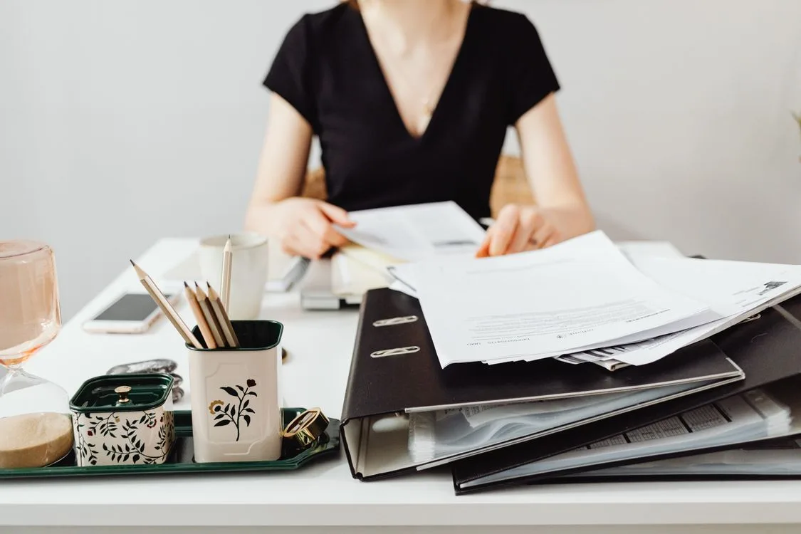 A person reviewing documents and files