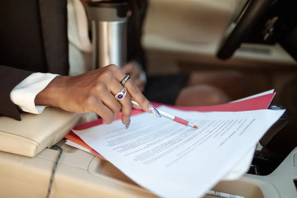 A person reviewing a paper with a pen