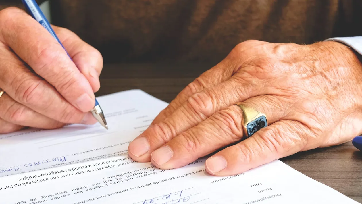 A person signing a paper