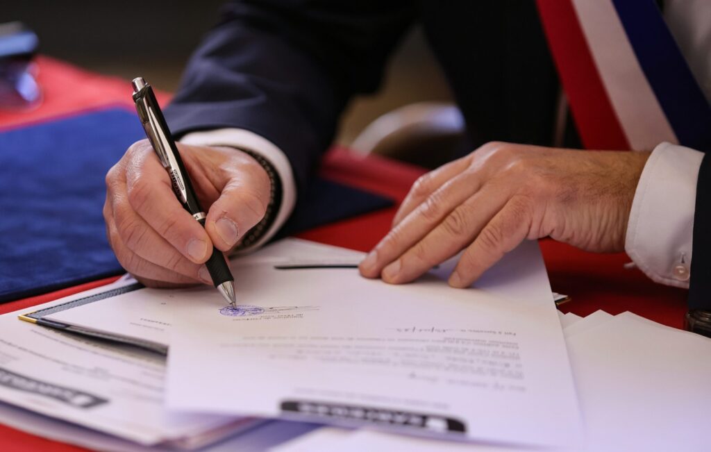 A person is signing a document